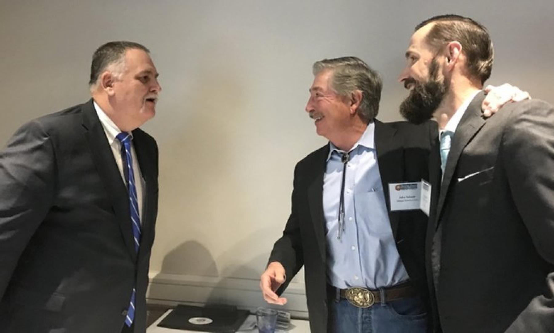 The Subsurface Irrigation Efficiency Project or SIEP sponsored a panel updating the Colorado Water Plan and its funding initiative. Prior to the forum, two of the panel participants, Terry Fankhouser, left, with the Colorado Cattlemen's Association, and water expert James Eklund, right, joke with John Salazar, center, about facial hair. Salazar is a former state agricultural commissioner. (Photo by Lynn Bartels)